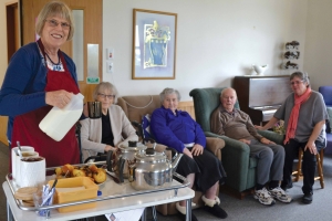 Kathleen serves morning tea. From left: Margaret Galloway, Helen Povey and Andy Galloway with Margaret looking on